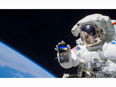 Az ingyenes NASA+ szolgáltatás reklámképe, amelyen egy űrhajós egy okostelefont tart a kezében a NASA+ alkalmazással az űrben. (Kép forrása: NASA)