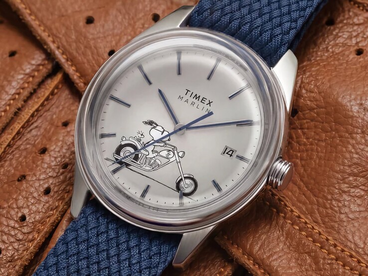 A Peanuts x Timex Marlin Jet Automatic Easy Rider szögletes elölnézete, amelyen kiemelkedik a domború üveg, az ezüstszínű rozsdamentes acél tok, a Snoopy-motívummal díszített számlap és a kék szövet szíj.