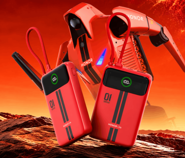 Két piros Honor Life powerbank beépített kijelzővel és csatlakoztatott kábelekkel, piros háttér előtt