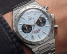 Közelkép a csuklón viselt Timex Q Timex Continental Chronograph TW2Y92400 óráról, amely jégkék, sugárirányú CD-stílusú számlappal, fekete kis számlapokkal, ezüst tachyméter kerettel és integrált rozsdamentes acél karkötővel rendelkezik.