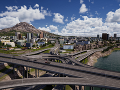 A City Masterplan vetítettképes felvétele, amely a komplex úthálózatot mutatja felhőkarcolókkal és épületekkel a háttérben