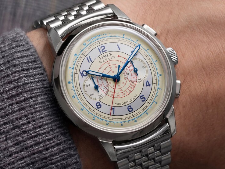 Timex Marlin Neo Classic kronográf krém színű számlappal, kék mutatókkal és rozsdamentes acél karkötővel, csuklón viselve.